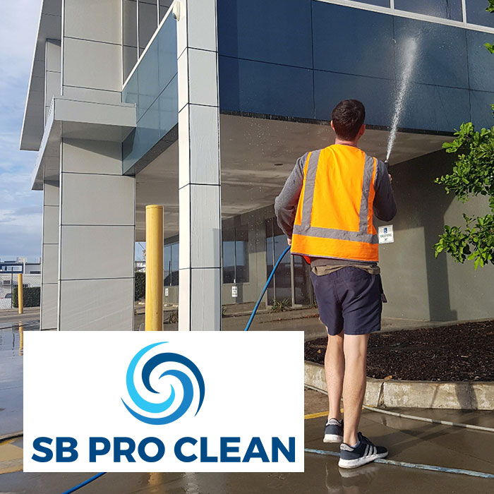 Steve softwashing exterior of building