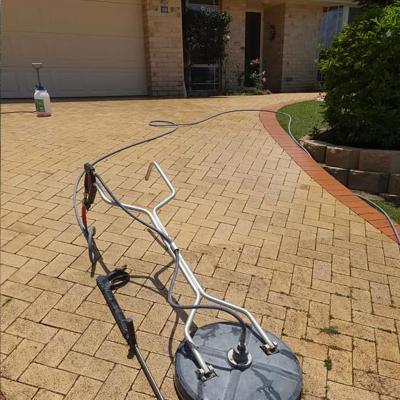 High pressure cleaning machine on driveway half done