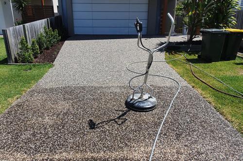 Pressure cleaning machine showing driveway half cleaned with huge difference
